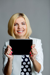 Image showing Smiling beautiful model holds tablet