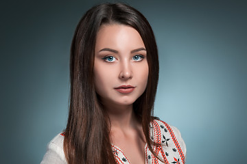 Image showing The beautiful girl in National Ukrainian Costume at studio.