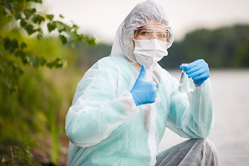 Image showing Chemist with bulb , river bank