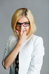 Image showing Beautiful young girl adjusts glasses