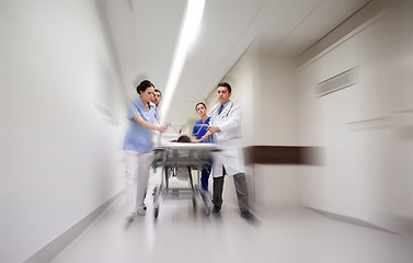 Image showing medics and patient on hospital gurney at emergency