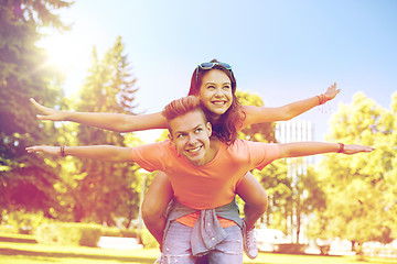 Image showing happy teenage couple having fun at summer park