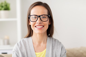 Image showing happy smiling middle aged woman in glasses at home