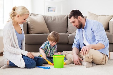 Image showing happy family playing with beach toys at home