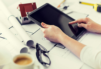 Image showing close up of hand with blueprint and tablet pc