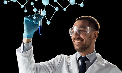 Image showing smiling scientist with test tube and molecules