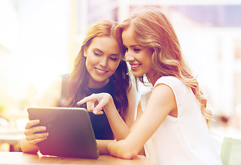 Image showing happy young women with tablet pc at outdoor cafe