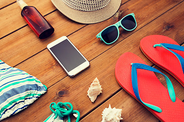 Image showing close up of smartphone and beach stuff