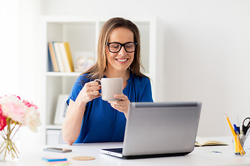 Image showing woman with laptop and coffee at home or office