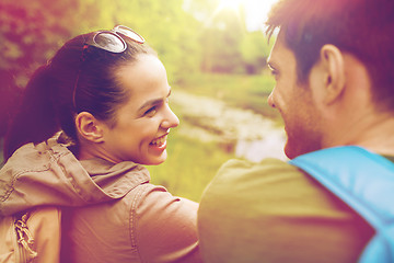 Image showing smiling couple with backpacks in nature