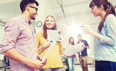 Image showing creative team with tablet pc talking at office