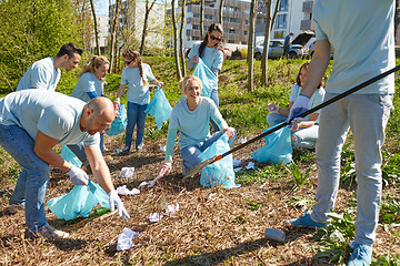 Image showing volunteers with garbage bags cleaning park area