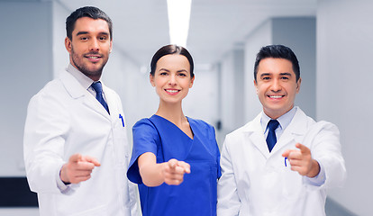 Image showing group of medics pointing finger on you at hospital