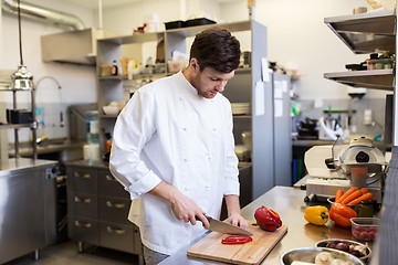 Image showing happy male chef cooking food at restaurant kitchen