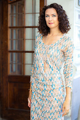 Image showing fashion. Pretty middle-aged woman in a beautiful summer dress ne