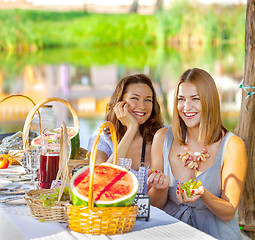 Image showing beautiful laughing women at a festive table