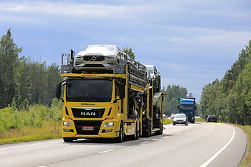 Image showing Yellow MAN Car Carrier Hauls New Cars