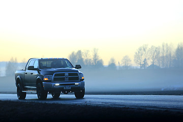 Image showing Dodge Pickup Truck on Foggy Sunset Road