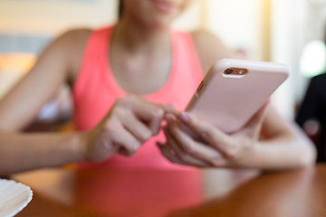 Image showing Woman sending sms on mobile phone