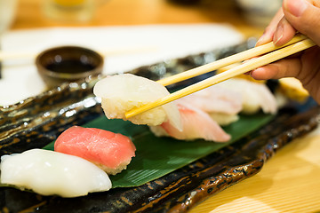 Image showing Sushi with chopsticks