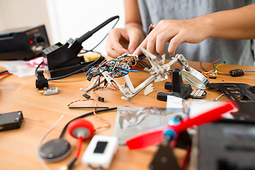 Image showing Man installing the component on drone body