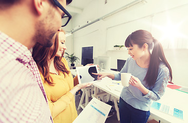 Image showing creative team with tablet pc talking at office