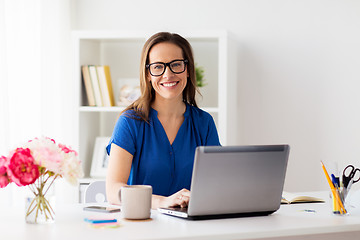 Image showing happy woman with laptop working at home or office