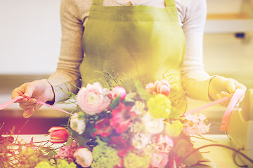 Image showing close up of woman making bunch at flower shop