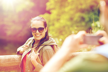 Image showing couple with backpacks taking picture by smartphone