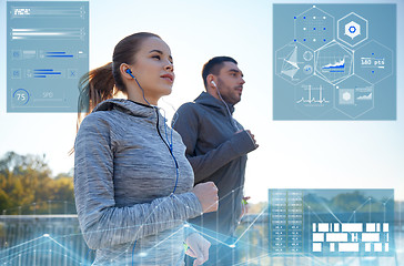 Image showing happy couple with earphones running outdoors