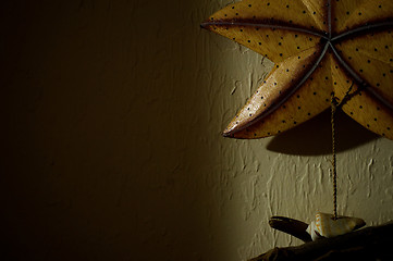 Image showing dark wall with wooden starfish