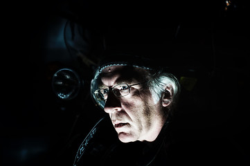 Image showing man in front of motorcycle lit from below