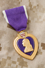 Image showing Purple Heart Medal Laying on Military Fatigues