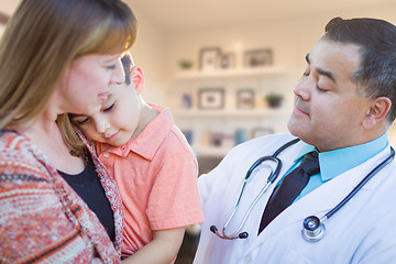 Image showing Young Sick Boy and Mother Visiting with Hispanic Doctor in Offic