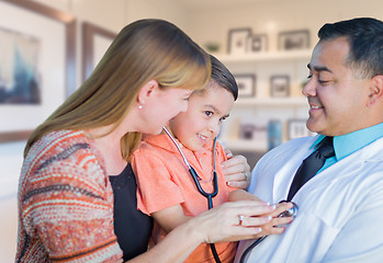 Image showing Young Boy and Mother Visiting with Hispanic Doctor in Office