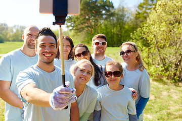 Image showing group of volunteers taking smartphone selfie