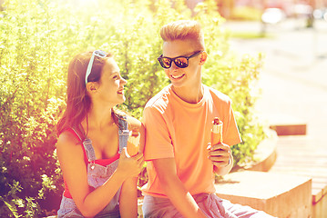 Image showing happy teenage couple eating hot dogs in city