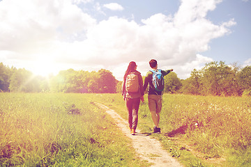 Image showing happy couple with backpacks hiking outdoors