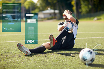 Image showing injured soccer player with ball on football field