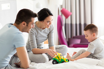 Image showing happy family in bed at home or hotel room