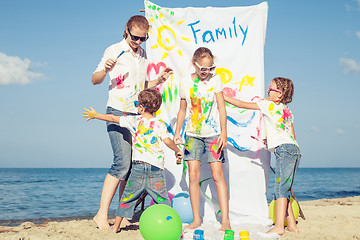 Image showing Mother and children playing on the beach at the day time.