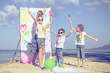 Image showing Mother and children playing on the beach at the day time.