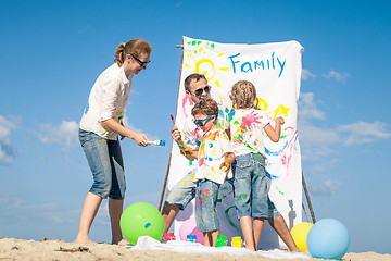 Image showing Happy family playing on the beach at the day time.