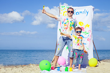 Image showing Father and son playing on the beach at the day time.