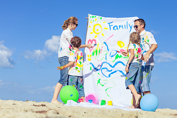 Image showing Happy family playing on the beach at the day time.