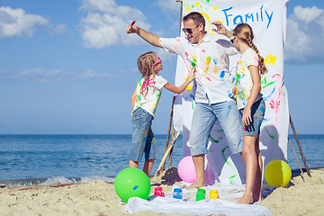 Image showing Father and children playing on the beach at the day time.