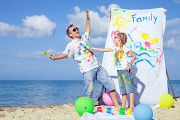 Image showing Father and daughter playing on the beach at the day time.