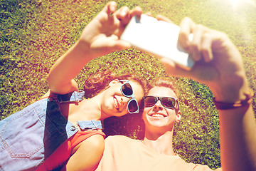 Image showing happy couple taking selfie on smartphone at summer