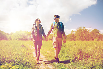 Image showing happy couple with backpacks hiking outdoors