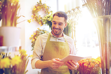 Image showing man with tablet pc computer at flower shop